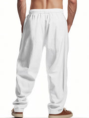 Men's white drawstring sweatpants with pockets and a relaxed fit.