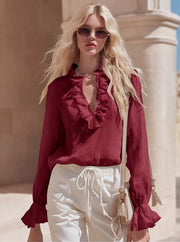 Burgundy ruffled V-neck maternity shirt with long bell sleeves.