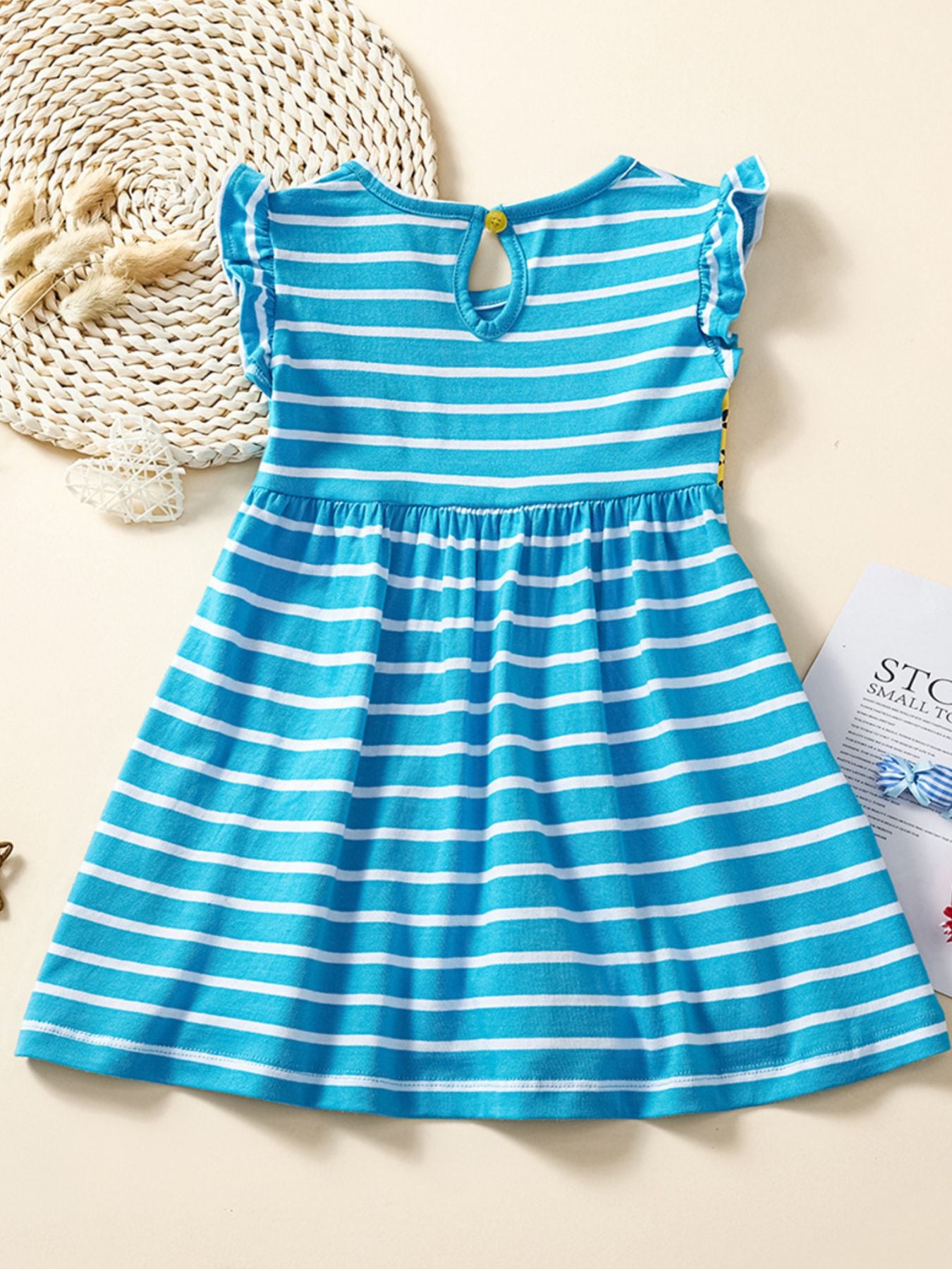 Blue and white striped cotton toddler dress with ruffled cap sleeves and animal appliqué detail.