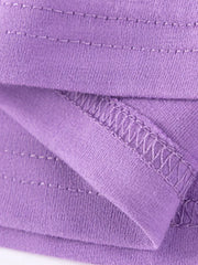 Purple cotton toddler dress detail showing stitching and fabric texture.