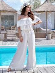 White off-shoulder ruffle palazzo jumpsuit with drawstring waist and wide legs.
