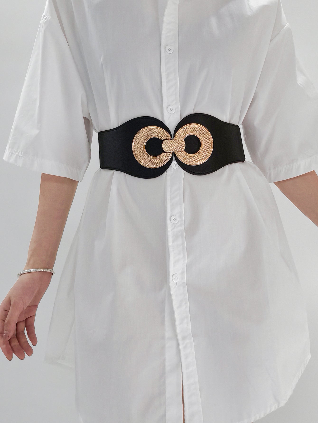 Black elastic waist cincher belt with gold double circle metalwork detail.