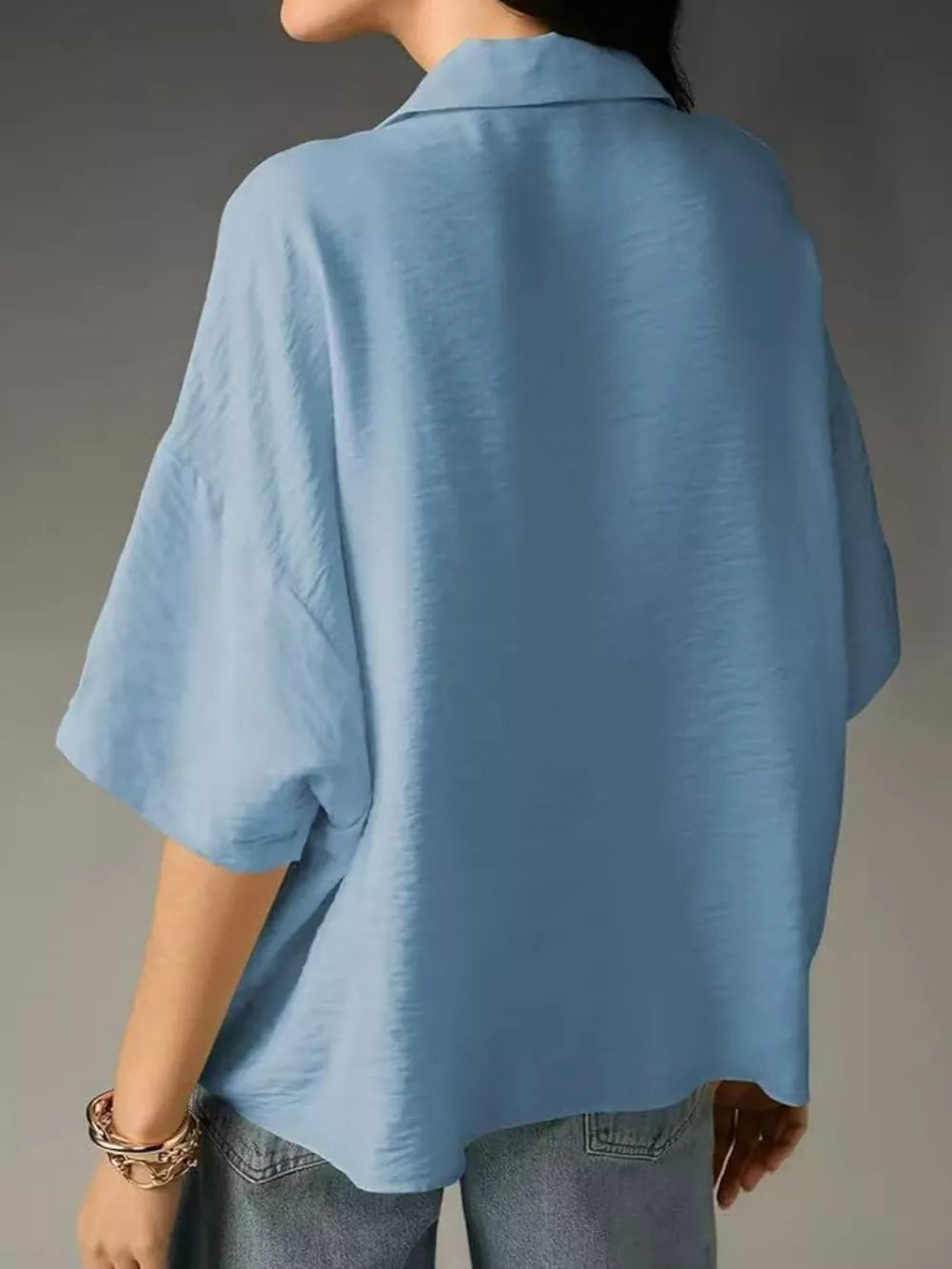 Light blue V-neck half sleeve shirt with a relaxed fit and textured fabric.