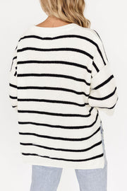 White and black striped knit pullover sweater with a crew neck and relaxed fit.