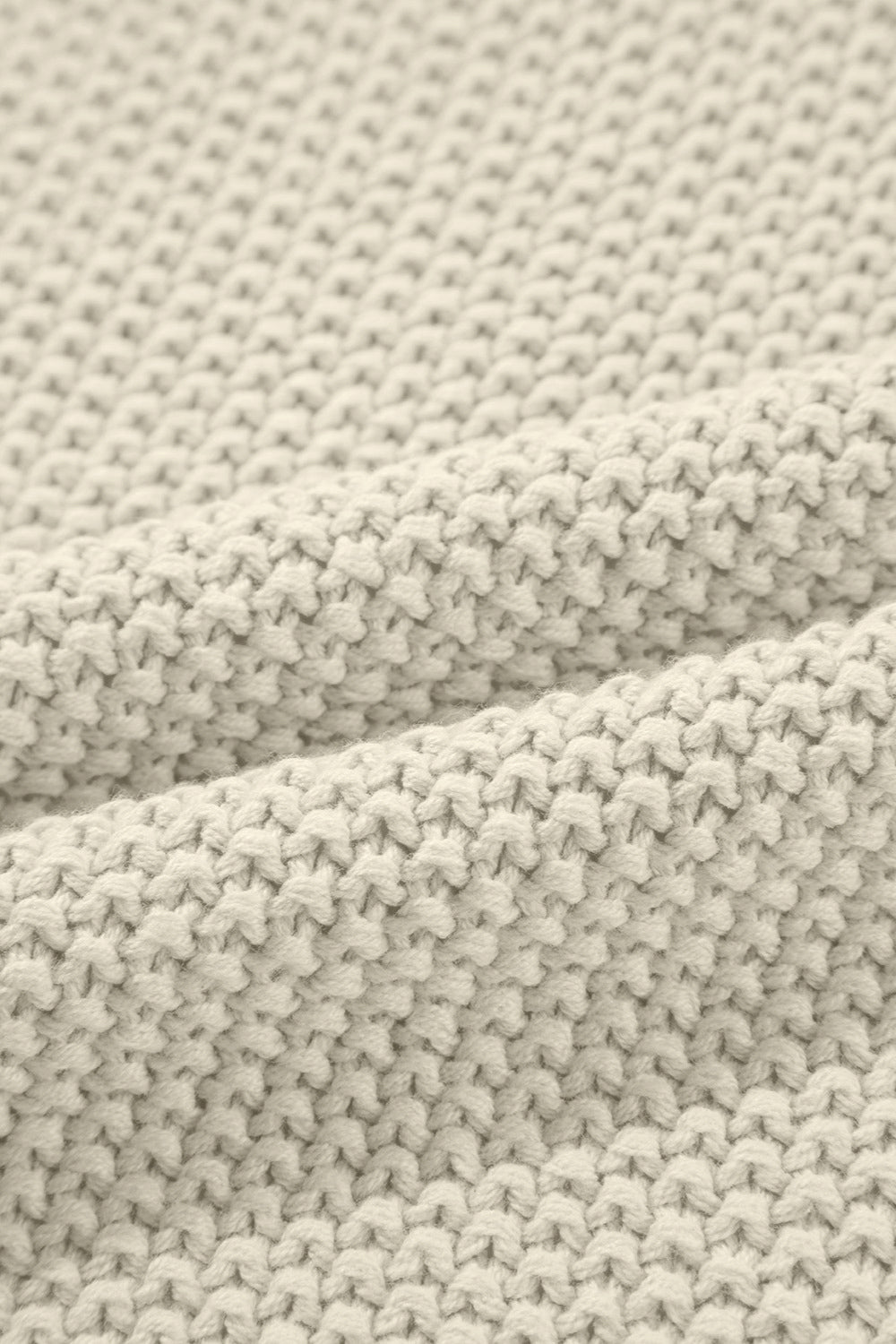 Boxy knit turtleneck shell in beige with a textured stitch pattern