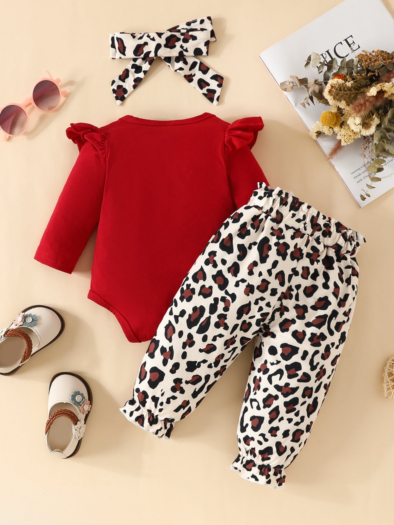 Red long sleeve bodysuit with ruffled sleeves and leopard print pants with ruffled cuffs.