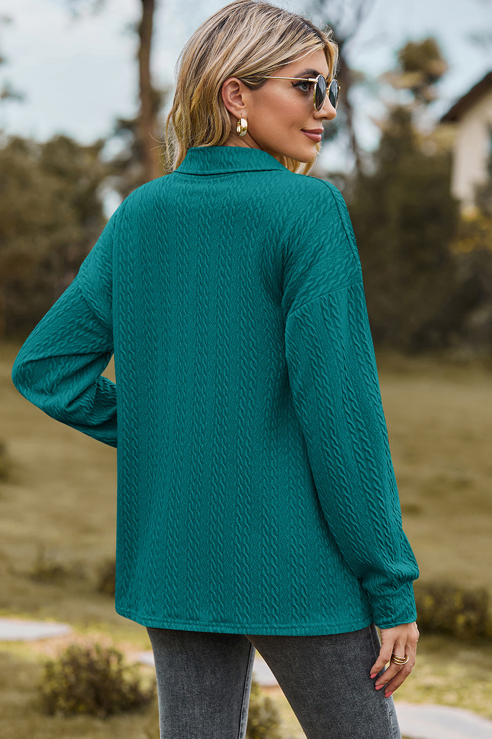 Teal textured polo-neck sweater with button detail and long sleeves.