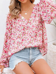 Maternity floral print v-neck long sleeve shirt in pink and white with balloon sleeves.
