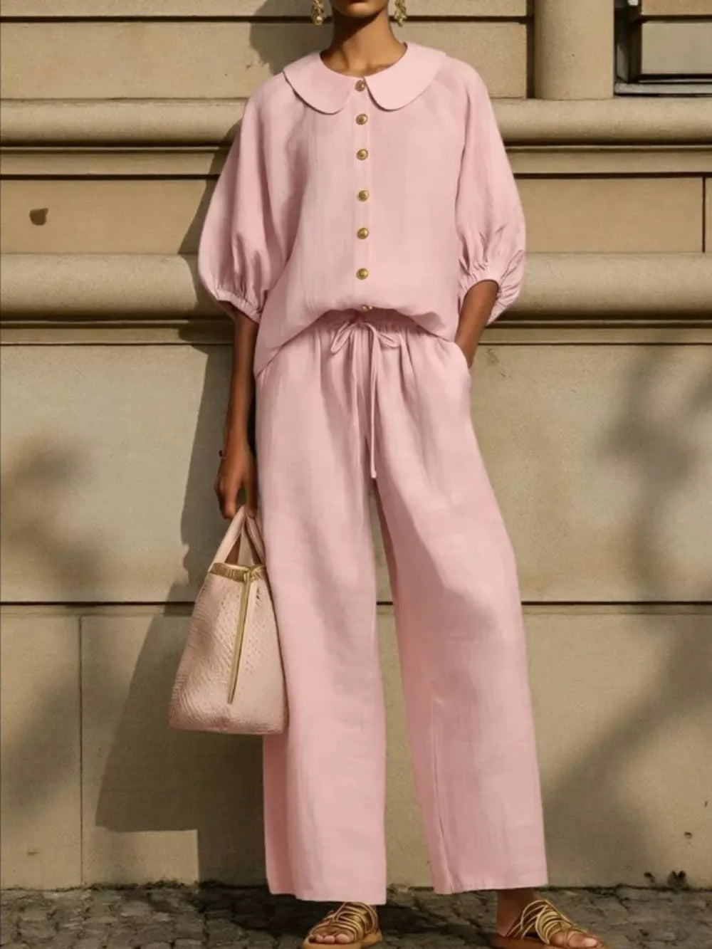 Pink linen two-piece set with button-down top, Peter Pan collar, puff sleeves, and wide-leg drawstring pants.