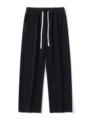 Black relaxed fit drawstring pants with elastic waist and white drawcords.