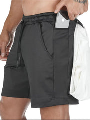 Black Tech-Knit cargo shorts with utility pockets, one holding a phone.