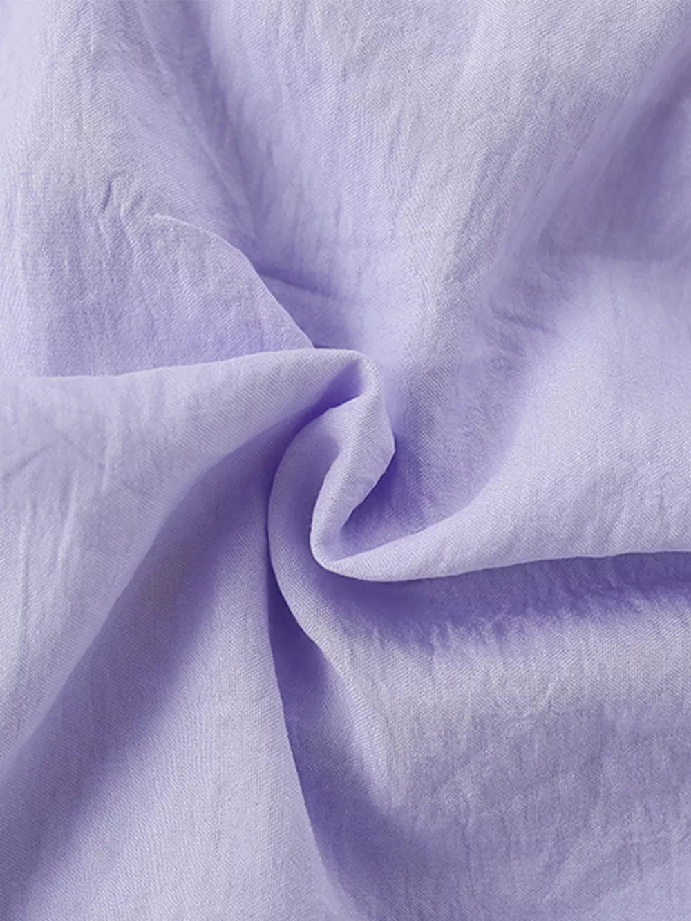 Lavender cotton fabric detail of a baby dress with Peter Pan collar.