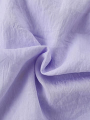 Lavender cotton fabric detail of a baby dress with Peter Pan collar.