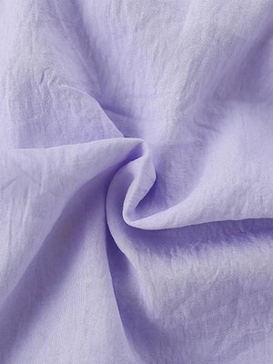 Lavender cotton fabric detail of a baby dress with Peter Pan collar.