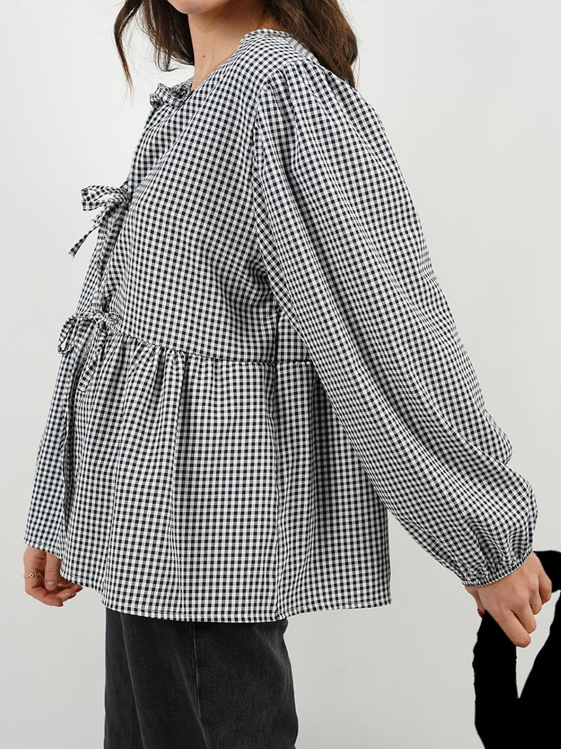 Black gingham tie-front peplum blouse with voluminous sleeves and tie details.