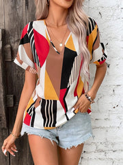 Geometric print v-neck blouse with short sleeves in multicolor.