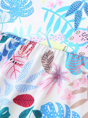 Baby cotton dress with playful tropical leaf print and ruffled hem detail
