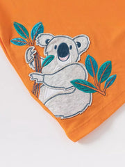 Orange cotton toddler t-shirt with a koala appliqué and leaves.