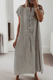 Black and white striped maxi dress with ruffle neckline and cap sleeves.