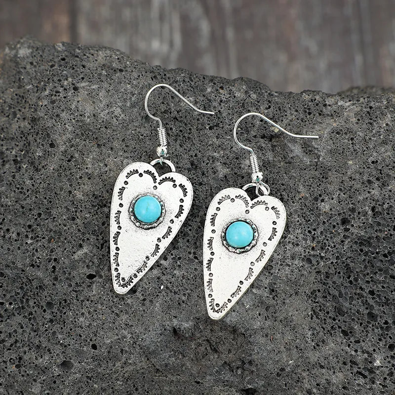 Silver heart-shaped earrings with turquoise stone and etched detail