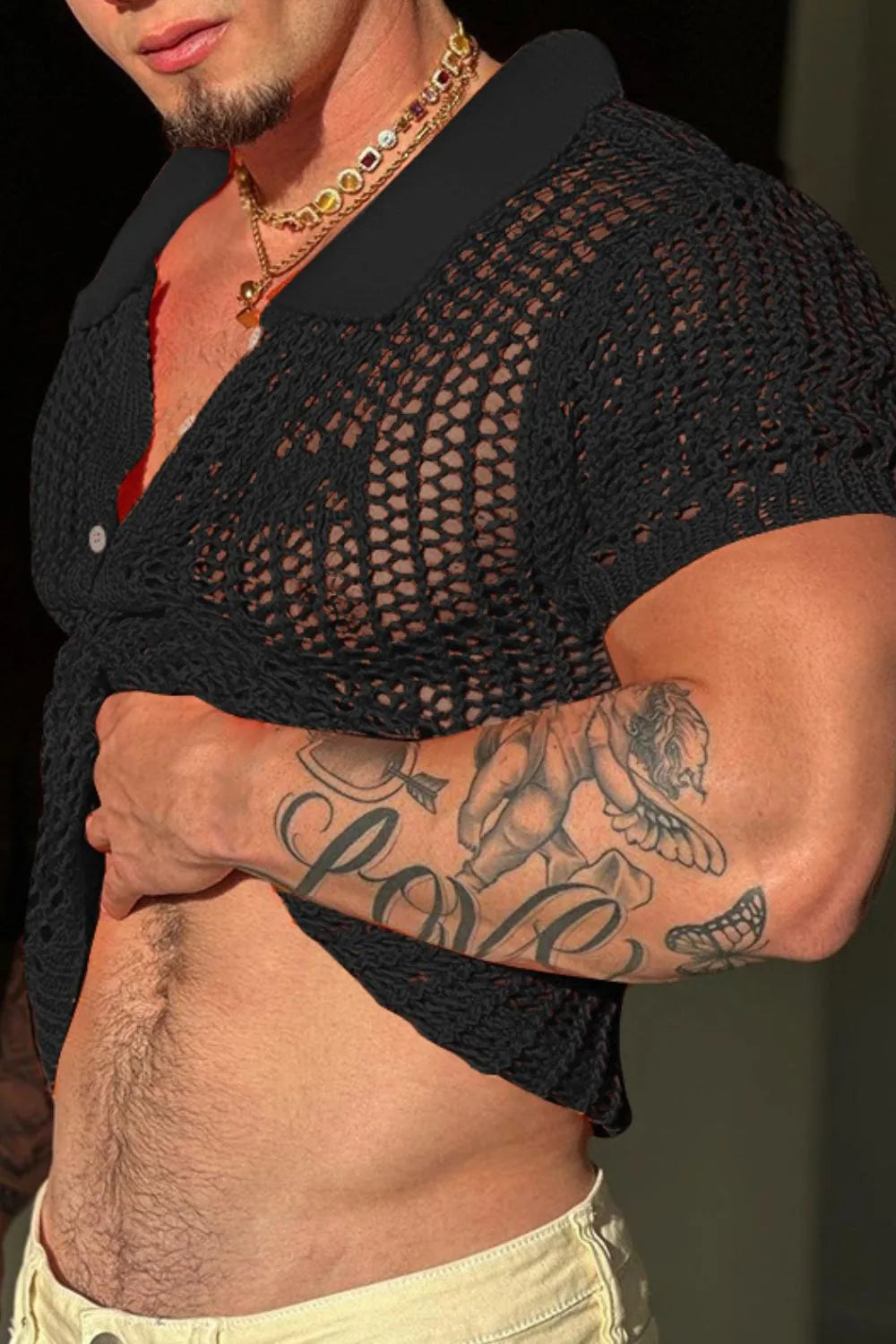Black openwork knit polo shirt with short sleeves and a collar