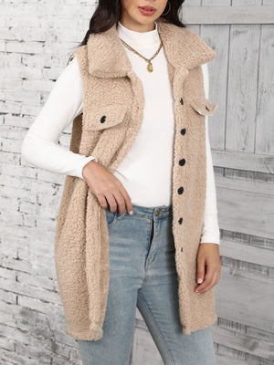 Tan sherpa utility vest with collar and button front, styled with a white turtleneck and jeans.