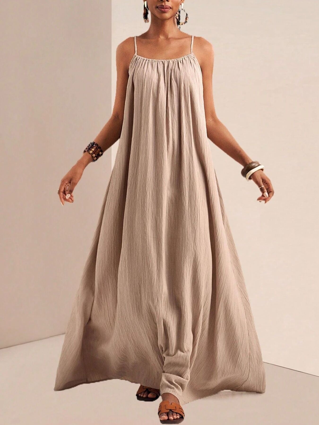 Khaki maxi dress with spaghetti straps and gathered neckline, flowing A-line skirt.