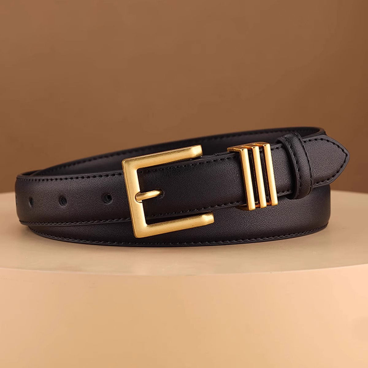 Black cowhide leather belt with a gold buckle and triple bar detail.