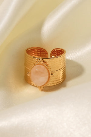 Textured cuff ring with oval stone, available in orange, brown, or sage.