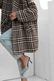 Oversized houndstooth cocoon coat in black and brown with button closure.