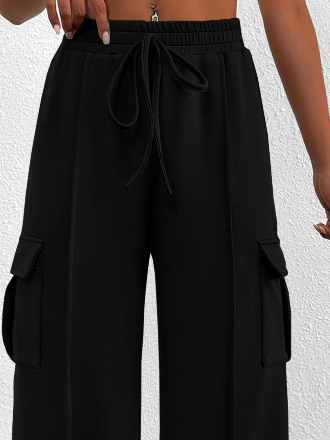 Black high waist cargo pants with drawstring and side pockets.