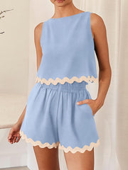 Pastel blue outfit set with scalloped trim on cropped top and shorts.