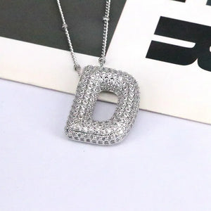 Silver bubble initial D pendant necklace with pave crystals on a delicate chain.