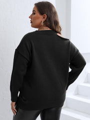 Black knit sweater with asymmetric shoulder detail and diamond pattern.