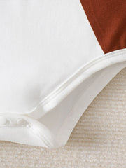 White baby bodysuit with brown color block detail and snap closure