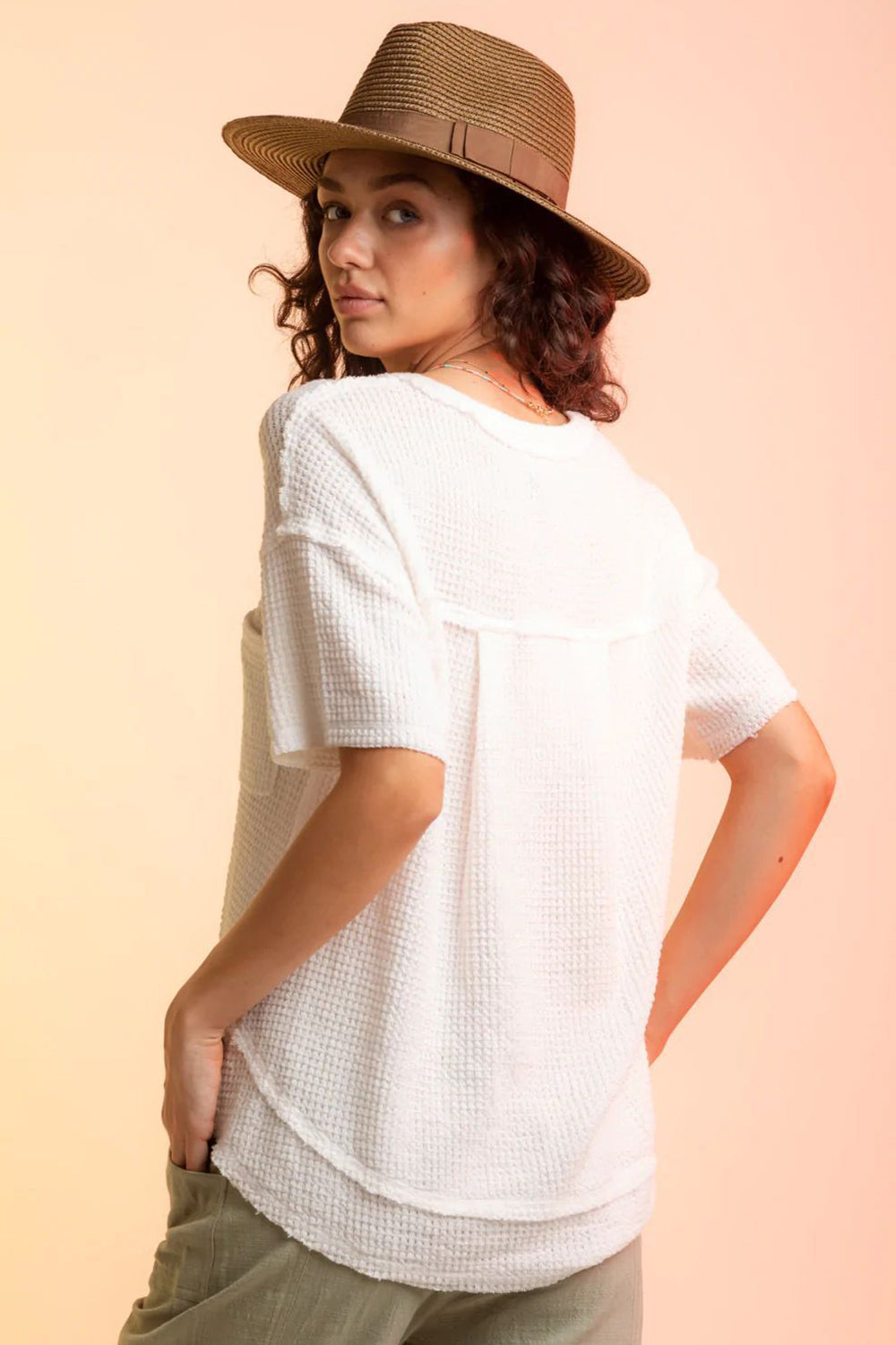 White waffle knit top with short sleeves and a relaxed fit.