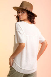 White waffle knit top with short sleeves and a relaxed fit.