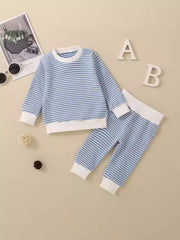 Baby knit set in light blue and white stripes, long sleeve top and pants with white cuffs.