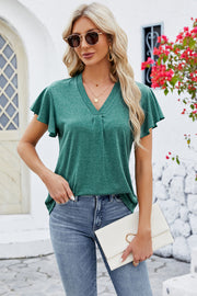 V-neck top in dark blue with pleated detail and flutter sleeves.