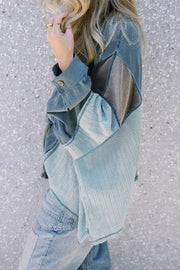 Panelled waffle knit blouson top in dusty blue with contrasting panels and blouson sleeves.