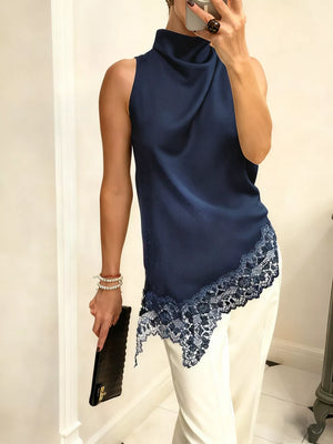 Dark blue asymmetrical cami top with lace trim and mock neck.