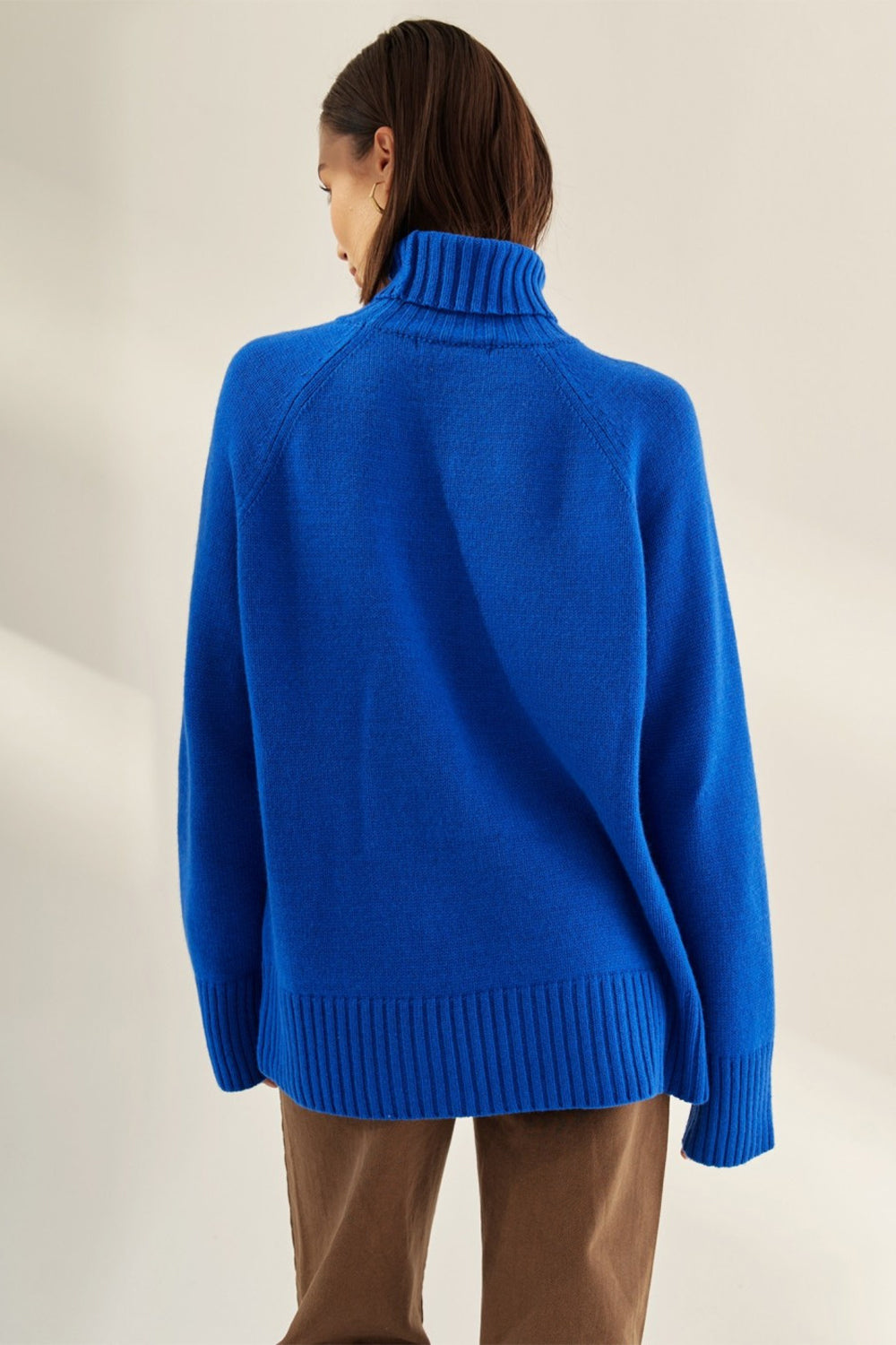Royal blue cashmere turtleneck sweater with raglan sleeves and ribbed hem.