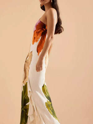 Floral one-shoulder maxi dress with cascading ruffle detail and bold bloom print.