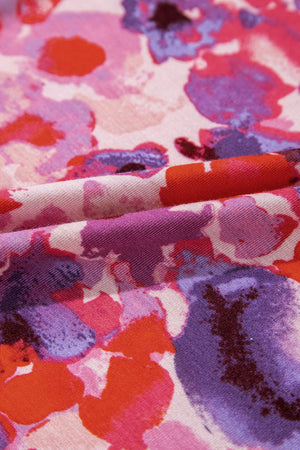 Painterly floral palazzo trousers in strawberry pink with abstract blooms in purple and orange.