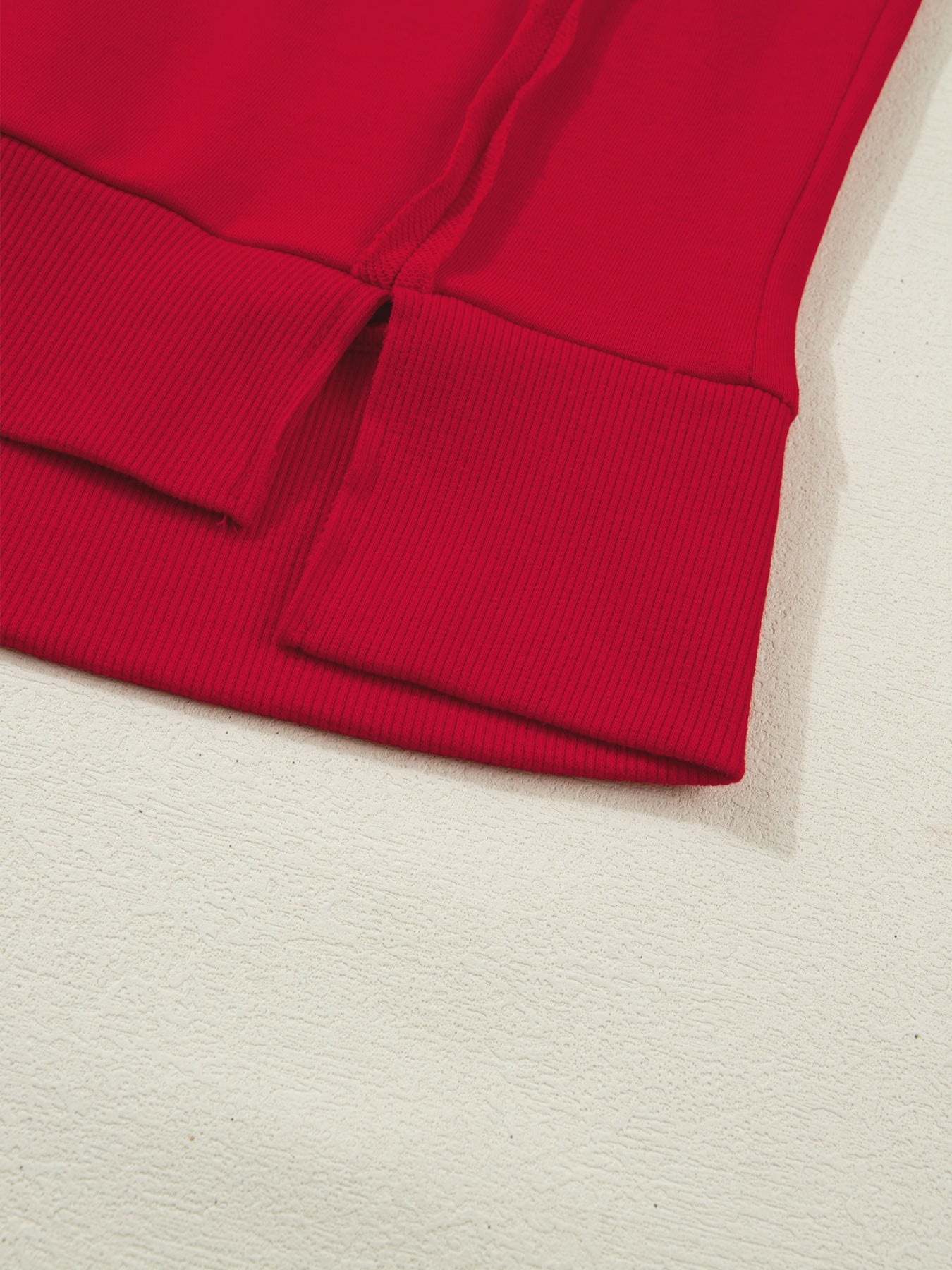 Red cotton blend tee with ribbed cuffs and side slits