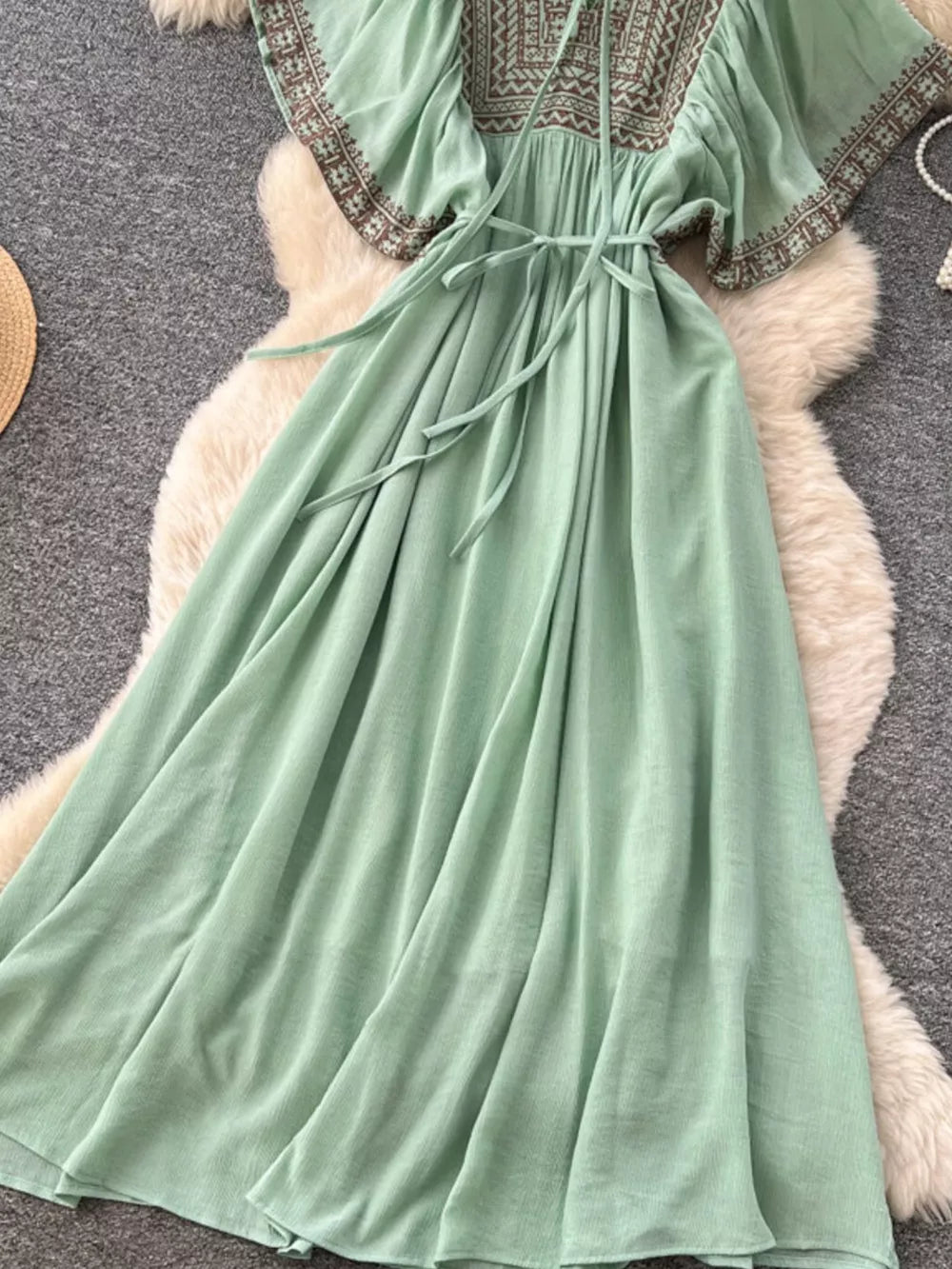 Mint green V-neck maxi dress with embroidered yoke and sleeves, tie waist.