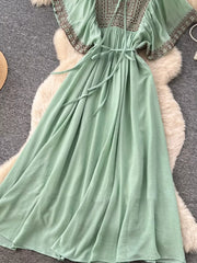 Mint green V-neck maxi dress with embroidered yoke and sleeves, tie waist.