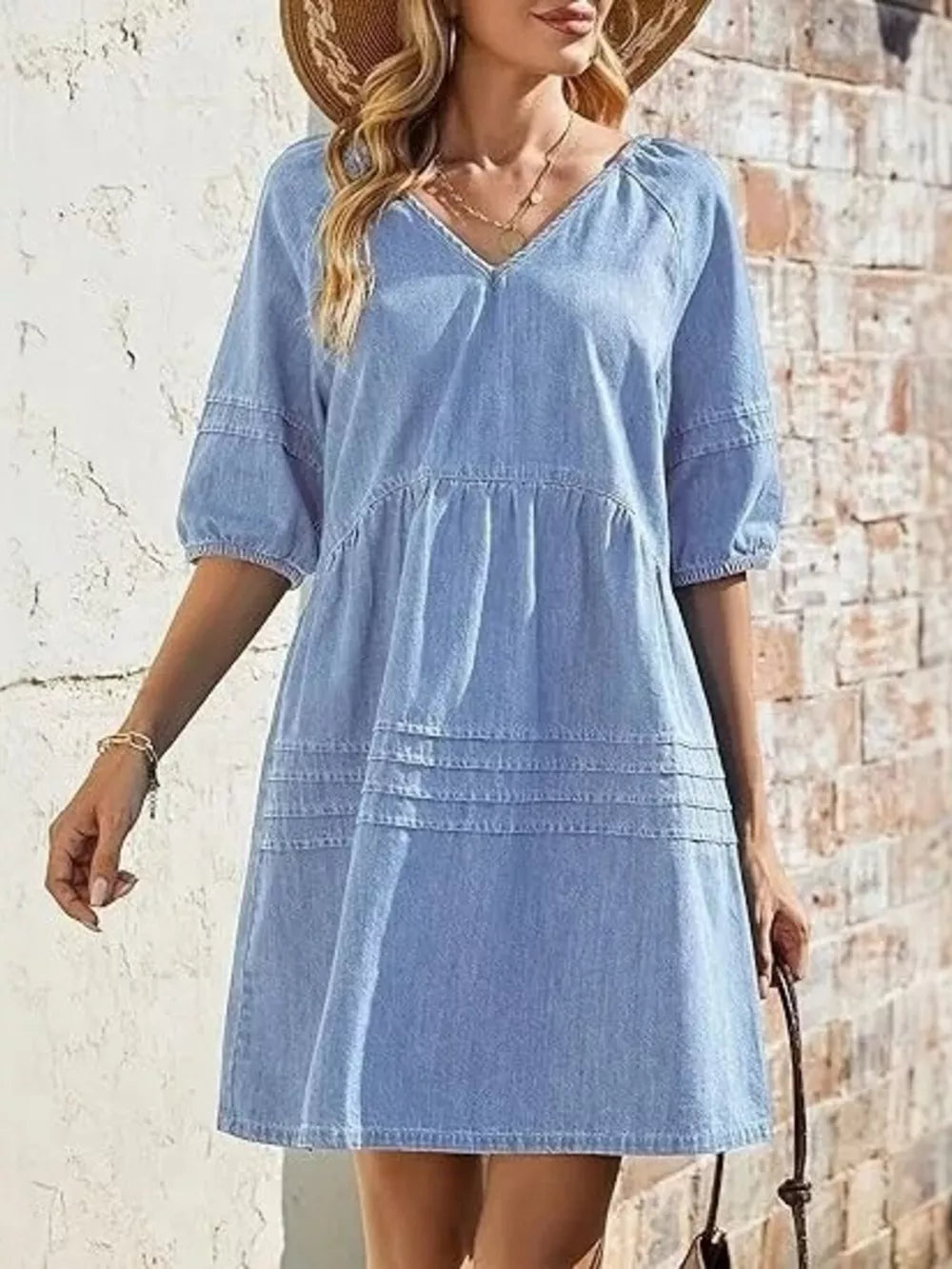 Light blue denim mini dress with puff sleeves and tiered skirt detail