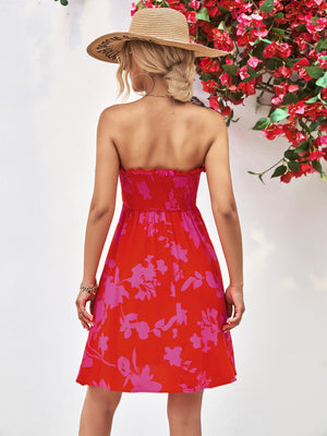 Smocked bandeau mini dress in red with pink floral print and A-line skirt.