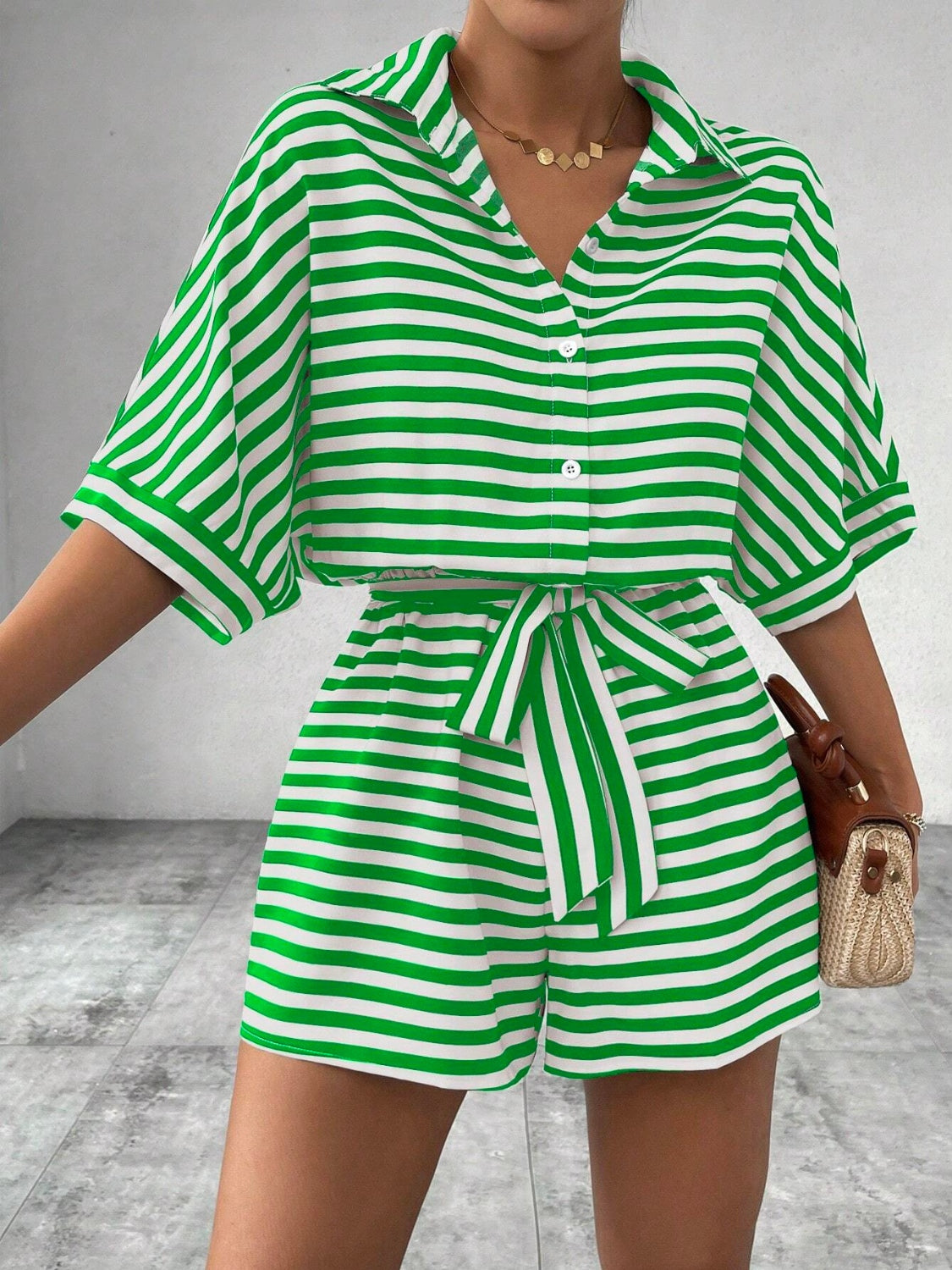 Green and white striped shirt romper with button front and self-tie belt.